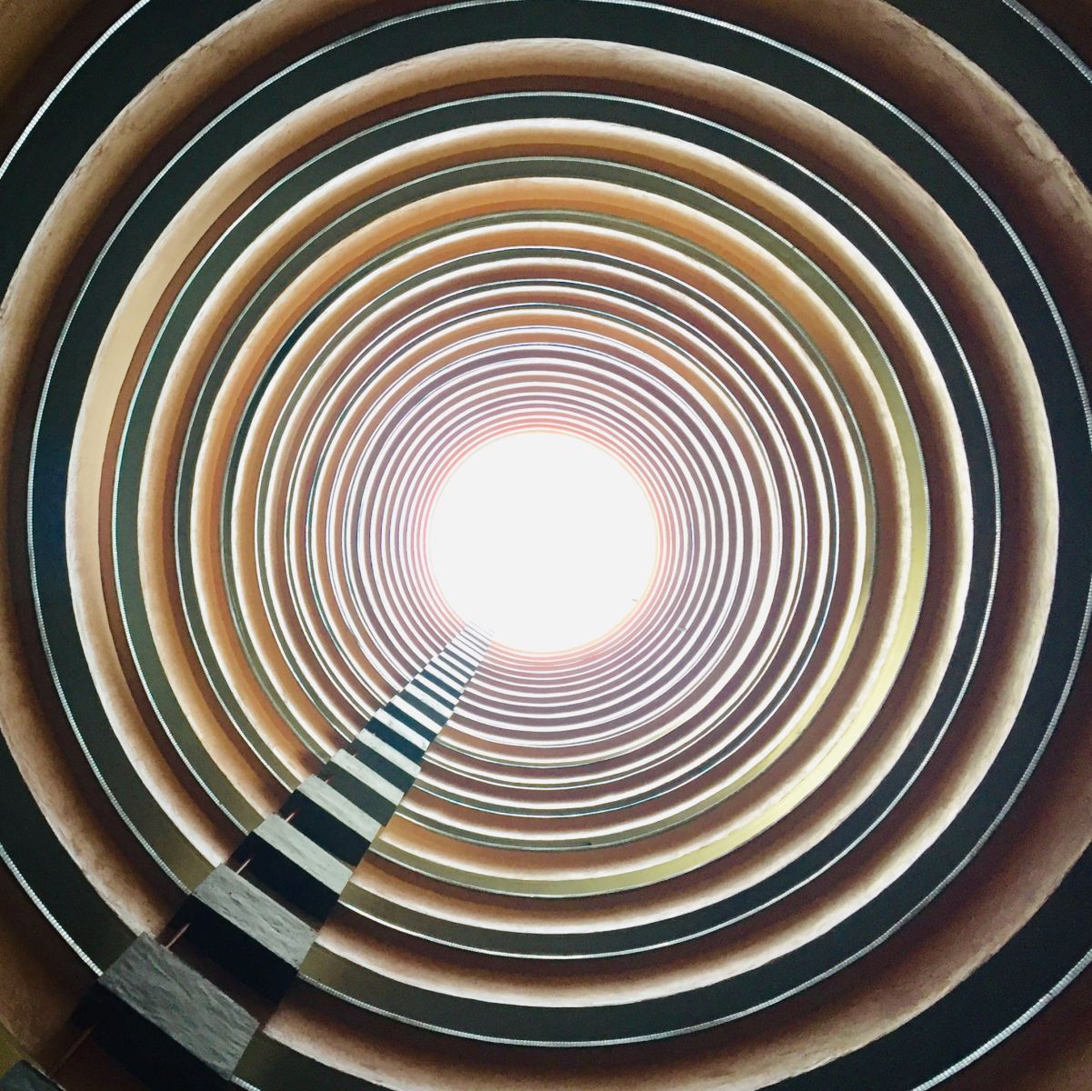 You'll feel as if you're time-traveling, witnessing the layers of light displayed through the tunnel of circles from bottom to top.