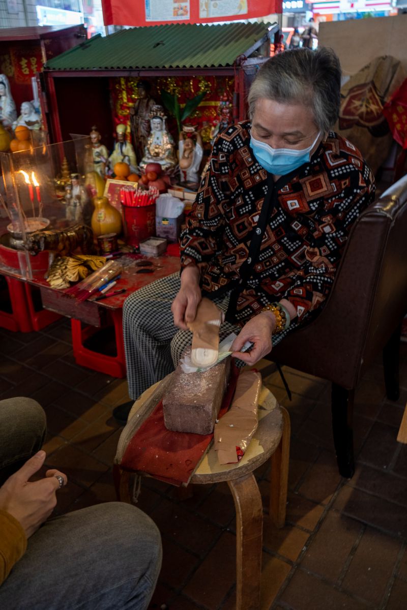 A practitioner performs the ceremony with a shoes