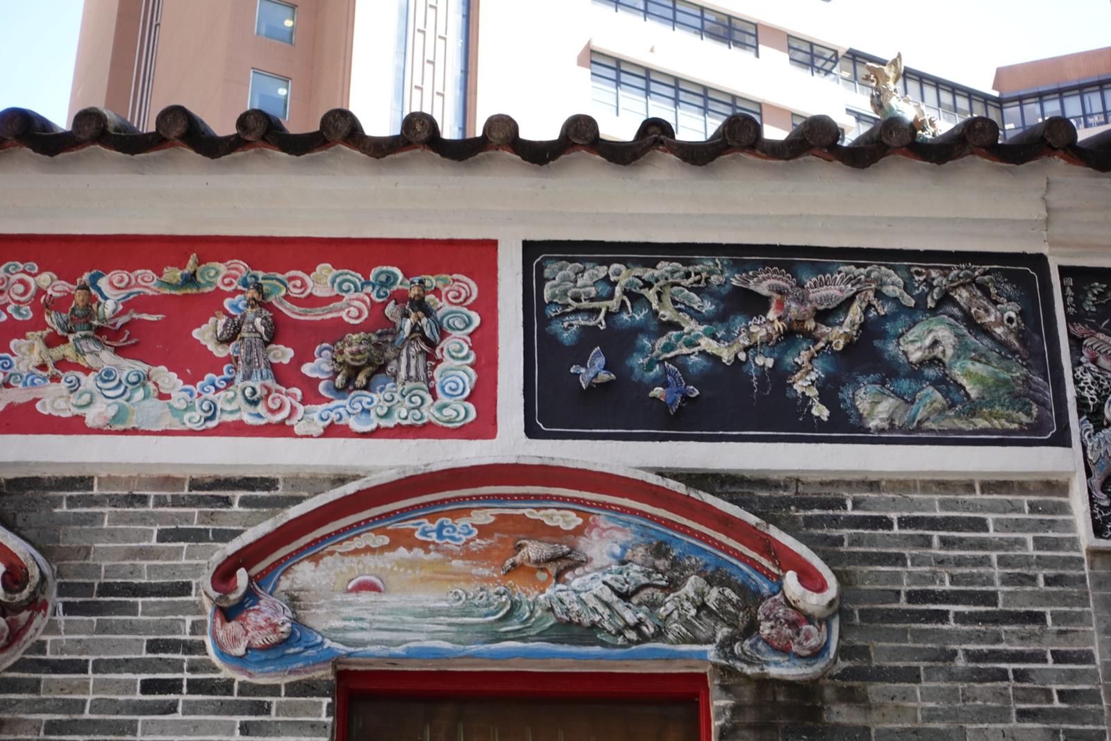 Decorative Ceramic arts on the wall depict Taoism stories and mythological legends